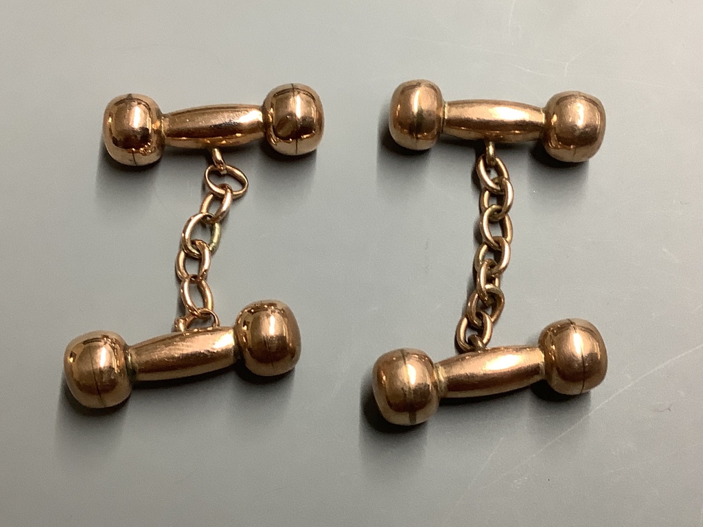 A pair of yellow metal overlaid dumbbell cufflinks